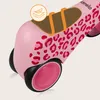 A close-up of a pink children's balance bike with a leopard print pattern. Náhled obrázku produktu