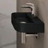 A modern black wall-mounted sink with a chrome faucet. Produktbild-Vorschau