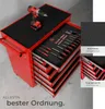 A red tool cart with drawers open, displaying various tools and a drill on top. Inset images highlight features like non-slip surfaces and ball-bearing slides. Náhled obrázku produktu