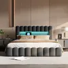 A modern bedroom with a grey upholstered bed featuring integrated LED lighting. Náhled obrázku produktu