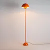 An orange floor lamp with a mushroom-shaped shade is shown against a plain background. Podgląd zdjęcia produktu