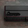 A close-up view of a black leather phone case with red stitching, showing the camera cutout and side buttons. Anteprima dell’immagine prodotto