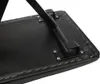 Close-up of the underside of a black padded piano bench with metal legs attached. Podgląd zdjęcia produktu