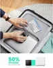 A person is packing a suitcase with a laptop and a small charger. Anteprima dell’immagine prodotto