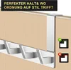 A silver over-the-door hook rack with six hooks, mounted on a light wood-grain door. There is a black banner at the top with white text and a checkmark/cross graphic on the right. Produktbild-Vorschau