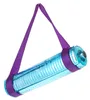 A blue yoga mat with purple straps, hanging diagonally against a white background. Podgląd zdjęcia produktu