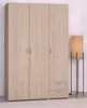 A three-door wardrobe with two drawers at the bottom, shown in a room setting with a floor lamp to the right. Produktbild-Vorschau