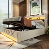 A modern bedroom with a beige upholstered bed frame, featuring a lifted mattress to reveal storage space underneath. The bed has an illuminated headboard with USB and Type-C ports, and LED lighting along the base. Produktbild-Vorschau