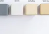 Four wooden blocks showing different finishes: grey, white, natural, and wax oil. Produktbild-Vorschau