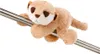 A plush toy meerkat is draped over a metal pole against a white background. Produktbild-Vorschau