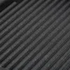 A close-up, diagonal view of a black, ribbed surface, likely a grill pan. Náhľad obrázku produktu