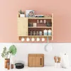 A wooden kitchen shelf mounted on a pink wall, filled with various kitchen items. Podgląd zdjęcia produktu