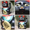 A collage of four close-up images of a black Maneki-neko (lucky cat) figurine. Produktbild-Vorschau