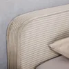 A close-up view of a beige upholstered bed frame with a corduroy-like texture and subtle pinstripes. Produktbild-Vorschau
