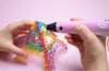 A child's hands are using a pink 3D pen to create a rainbow-colored Eiffel Tower model. Náhľad obrázku produktu