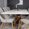 A dining table with chairs in a modern dining room setting. Produktbild-Vorschau