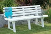 A white plastic garden bench sits on a grassy lawn in front of a stone wall and some greenery. Anteprima dell’immagine prodotto