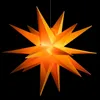 A bright orange star-shaped lantern hangs against a black background. Produktbild-Vorschau