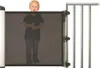 A young child stands behind a black mesh safety gate attached to a silver railing. Náhľad obrázku produktu