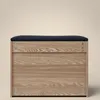A front view of a wooden shoe cabinet with a dark blue upholstered seat on top, set against a plain, light beige background. Náhľad obrázku produktu