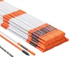 A pile of orange and white driveway markers with a drill bit in the foreground. Podgląd zdjęcia produktu