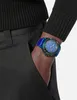A person's arm wearing a watch is shown with their hand in their pocket. Podgląd zdjęcia produktu