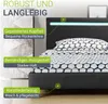 A close-up view of a bed with descriptive text overlays highlighting its features. Produktbild-Vorschau