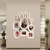 A multi-photo frame collage with the word 'FAMILY' above it, mounted on a wall. Produktbild-Vorschau