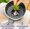 A hand is adding herbs to a kitchen appliance, with text overlays indicating features. Produktbild-Vorschau