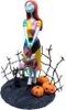 A collectible figure of Sally from The Nightmare Before Christmas, standing on a base with pumpkins and a black cat. Podgląd zdjęcia produktu
