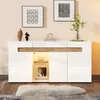 A modern white sideboard with wood accents, decorated with framed art and decorative objects, set in a living room. Voir les images du produit