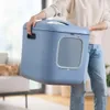 A person is holding a blue cat litter box in a room. Náhľad obrázku produktu