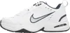 A side view of a white Nike Air Monarch IV sneaker with navy blue accents. Produktbild-Vorschau