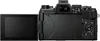 The back view of a black digital camera with its screen flipped out. Podgląd zdjęcia produktu