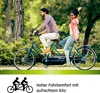 A couple riding a tandem bicycle in a park. Produktbild-Vorschau