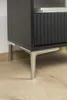 Close-up of the bottom of a black cabinet with silver metal legs. Produktbild-Vorschau