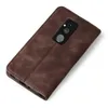 A brown leather flip case for a smartphone, shown from the back with the camera module visible. Produktbild-Vorschau
