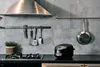 A kitchen scene with a rice cooker, stove, pots, and utensils. Produktbild-Vorschau