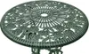 A close-up, top-down view of a green, ornate, round bistro table top with a floral design. Voir les images du produit