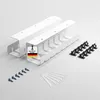 A set of white cable management accessories, including two channels, screws, and clips, arranged on a white background. Produktbild-Vorschau