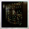 Glow-in-the-dark snowflake stickers on a window at night. Podgląd zdjęcia produktu