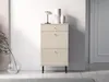 A tall, narrow beige cabinet with drawers and a fluted door section, placed against a white wall. Náhľad obrázku produktu