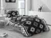 A bedroom scene with a bed made up with gray cotton bedding. Produktbild-Vorschau