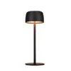 A black LED table lamp with a round base and a dome-shaped shade, shown against a white background. Produktbild-Vorschau