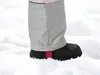 A close-up of a child's snowsuit leg and boot in the snow. Produktbild-Vorschau
