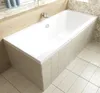 A white rectangular bathtub with a tiled surround and floor in a bathroom setting. Produktbild-Vorschau