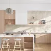 A modern kitchen with light wood cabinets and a white island. Anteprima dell’immagine prodotto
