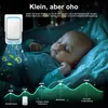 A baby sleeping peacefully in a crib, with an air purifier shown in the foreground emitting clean air. A decibel graph is displayed at the bottom, illustrating the quiet operation of the device. Produktbild-Vorschau