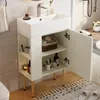 A white bathroom vanity with a sink and open cabinet doors, showcasing storage shelves and gold legs, set in a bathroom environment. Podgląd zdjęcia produktu