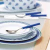 Table setting with plates and spoons. Produktbild-Vorschau